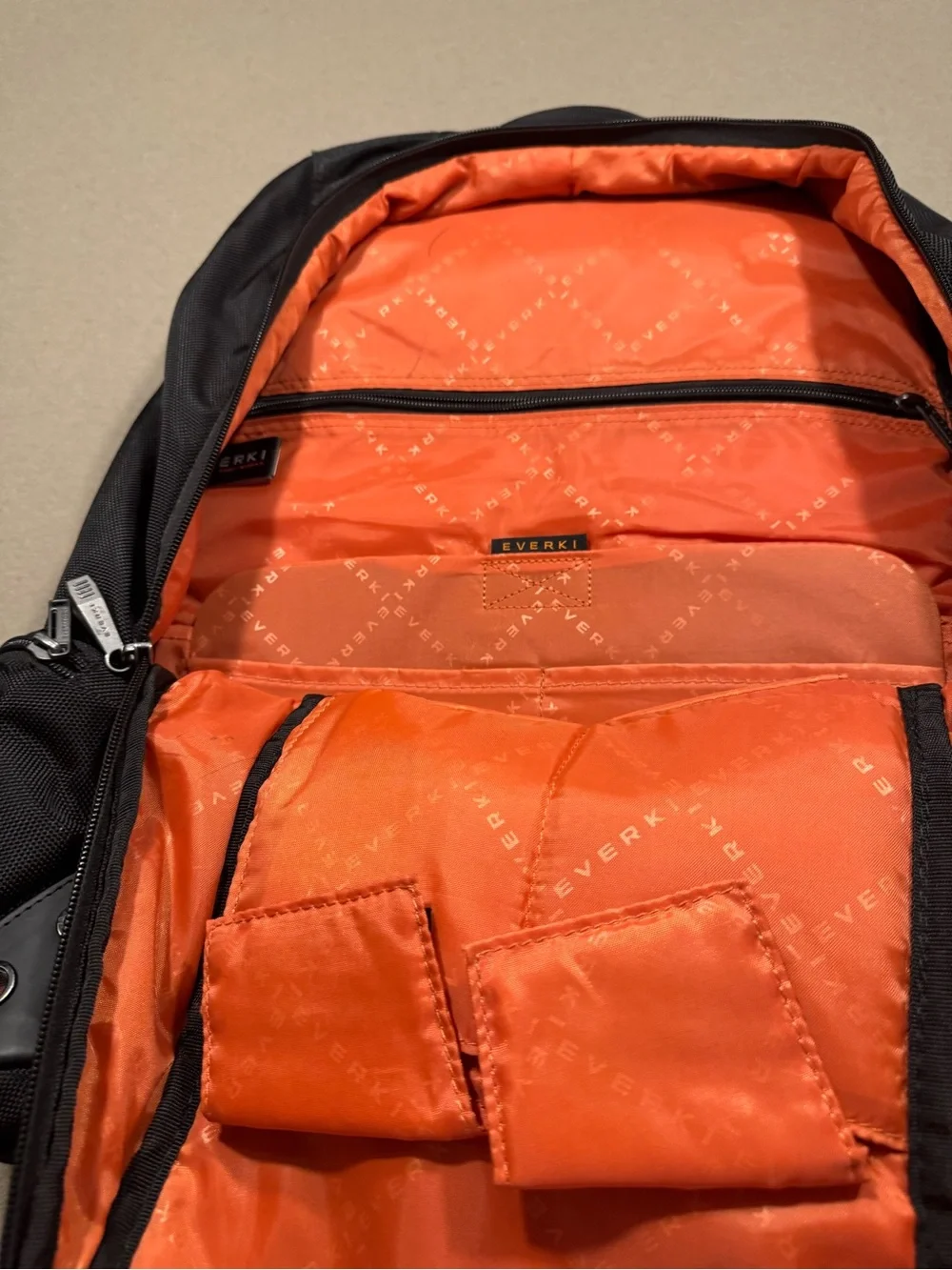 Black Men's Travel Backpack with Orange Accents Everki large laptop bag.